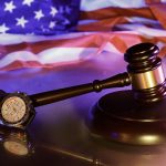 Judge’s gavel and watch symbolizing arbitration vs lawsuit decisions under California Lemon Law
