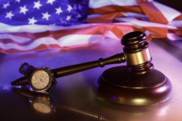 Judge’s gavel and watch symbolizing arbitration vs lawsuit decisions under California Lemon Law